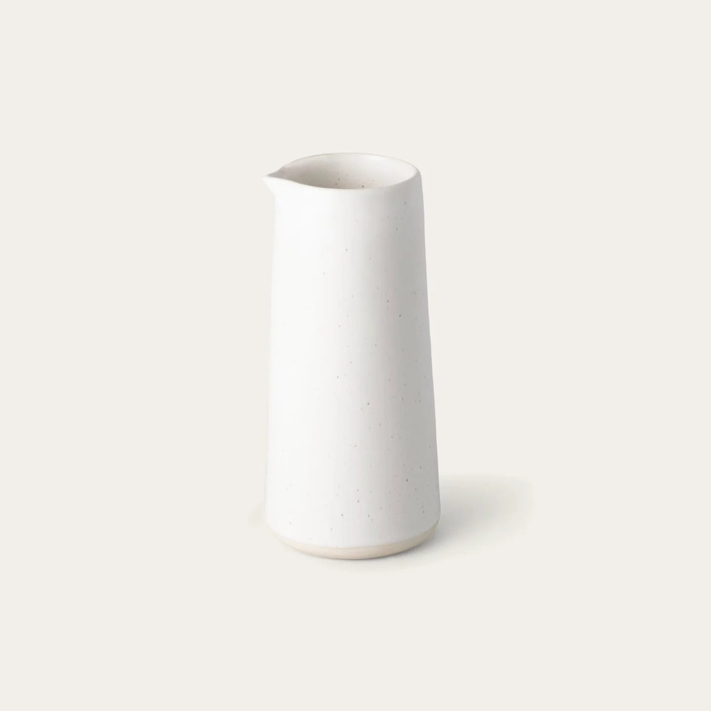 White ceramic vase on a light gray background