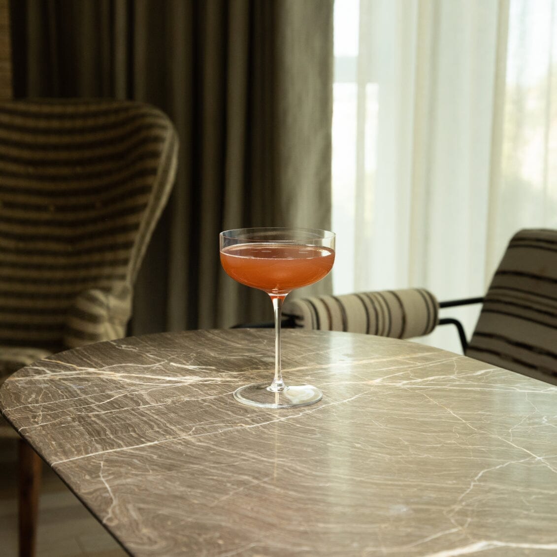 Fable Coupe Glass Pro filled with cocktail