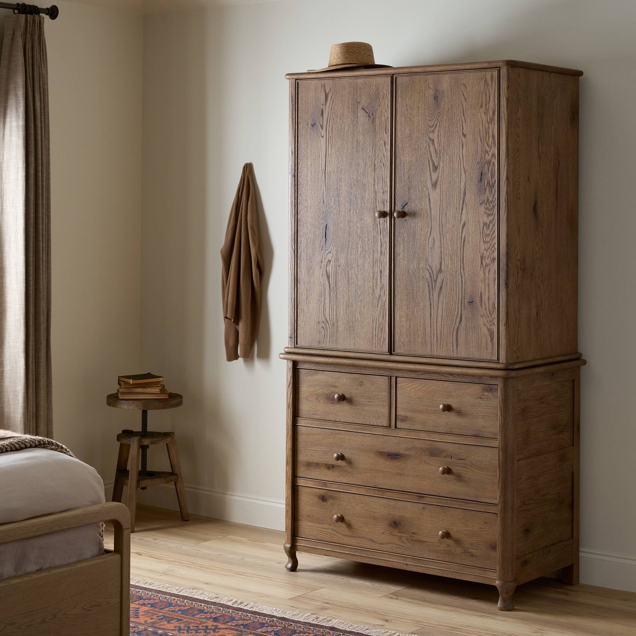 Pika Armoire in Weathered Oak styled in a bedroom setting