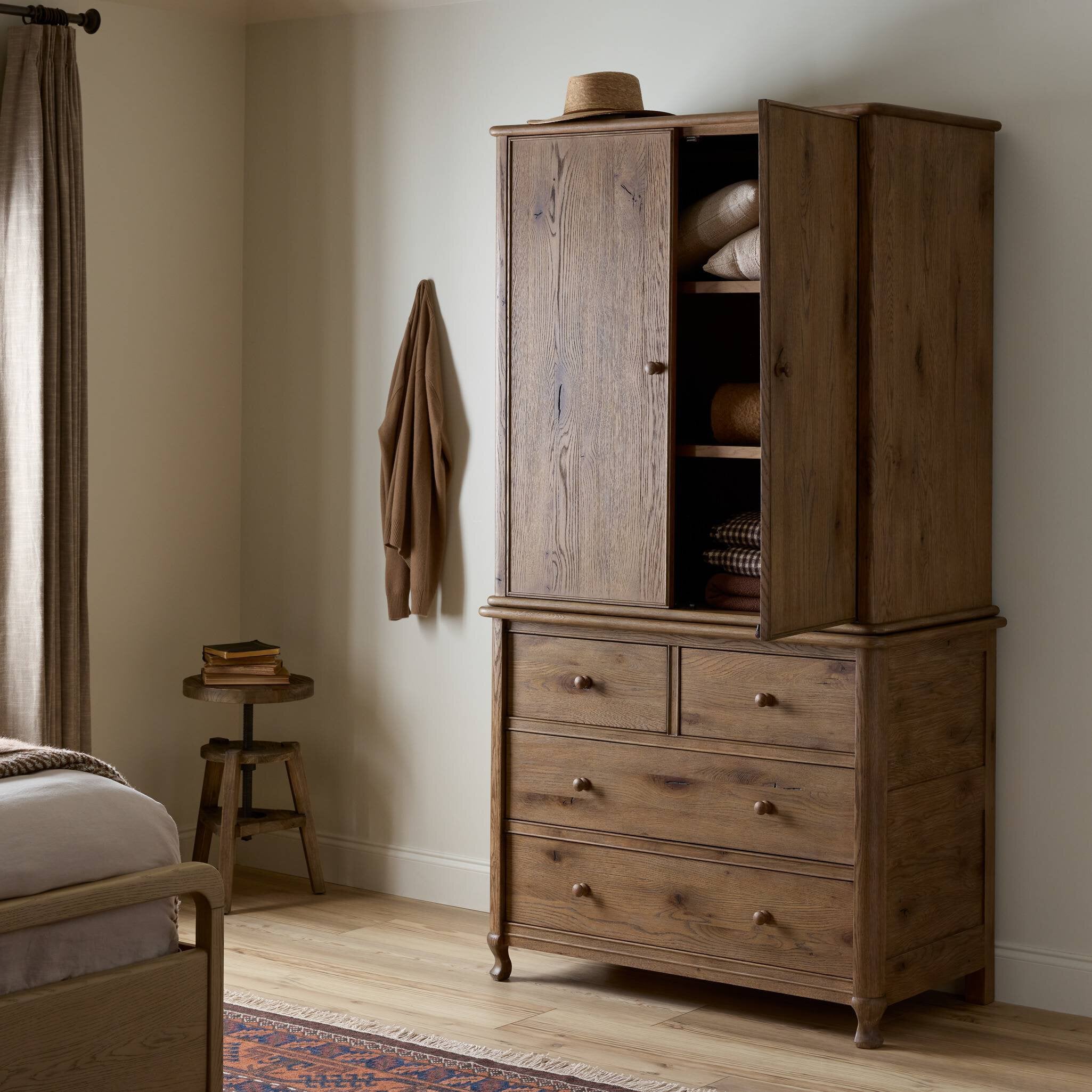 Pika Armoire in Weathered Oak styled in a bedroom