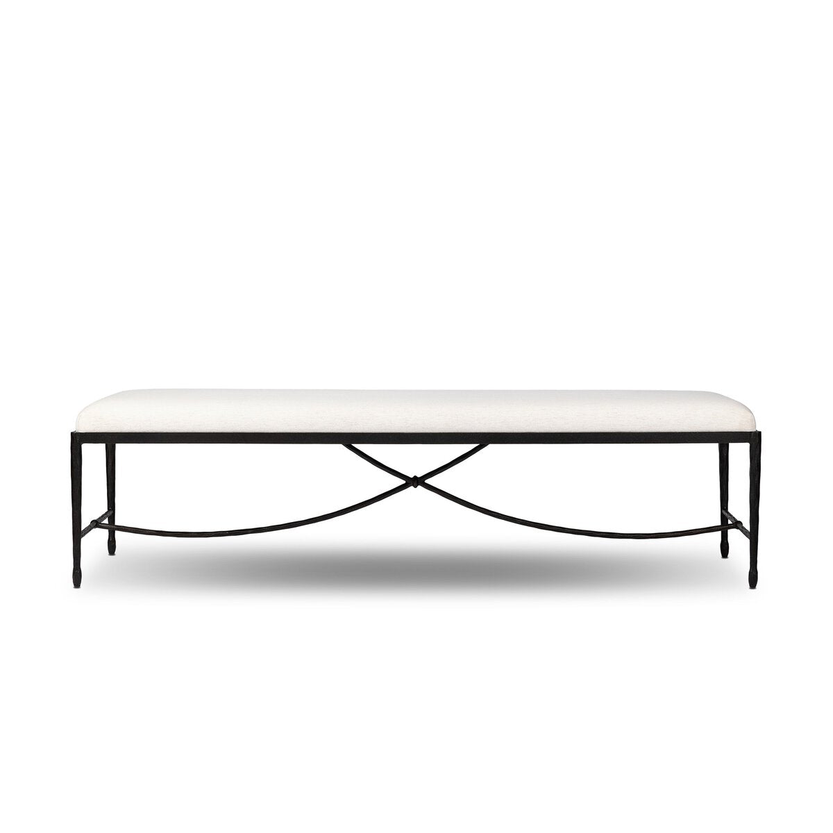 Four Hands Jade Accent Bench in Crypton Nomad Snow, a cream performance-weave cushion on a black wrought iron frame with a curved X-stretcher base