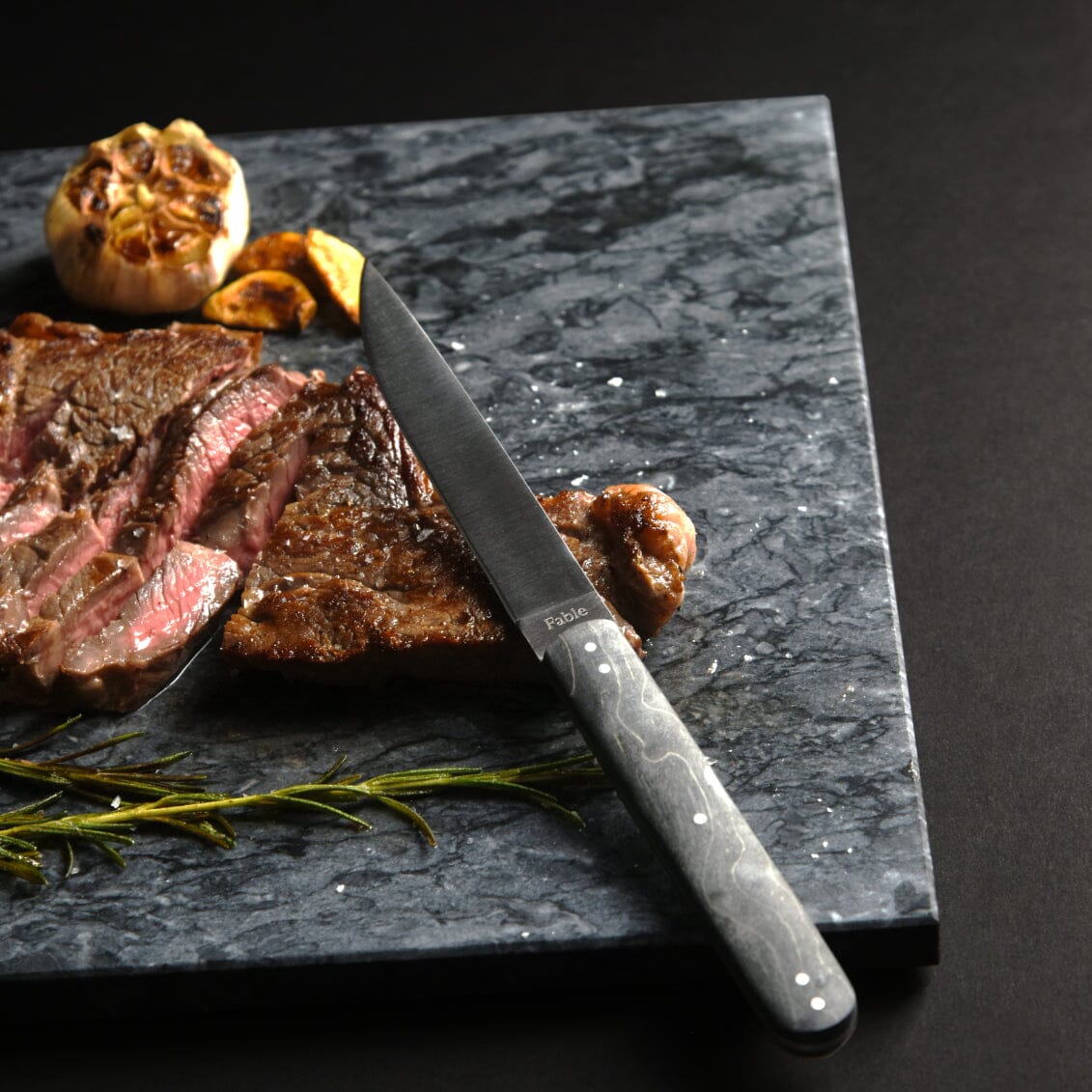 Sliced steak with Fable steak knife on marble slab